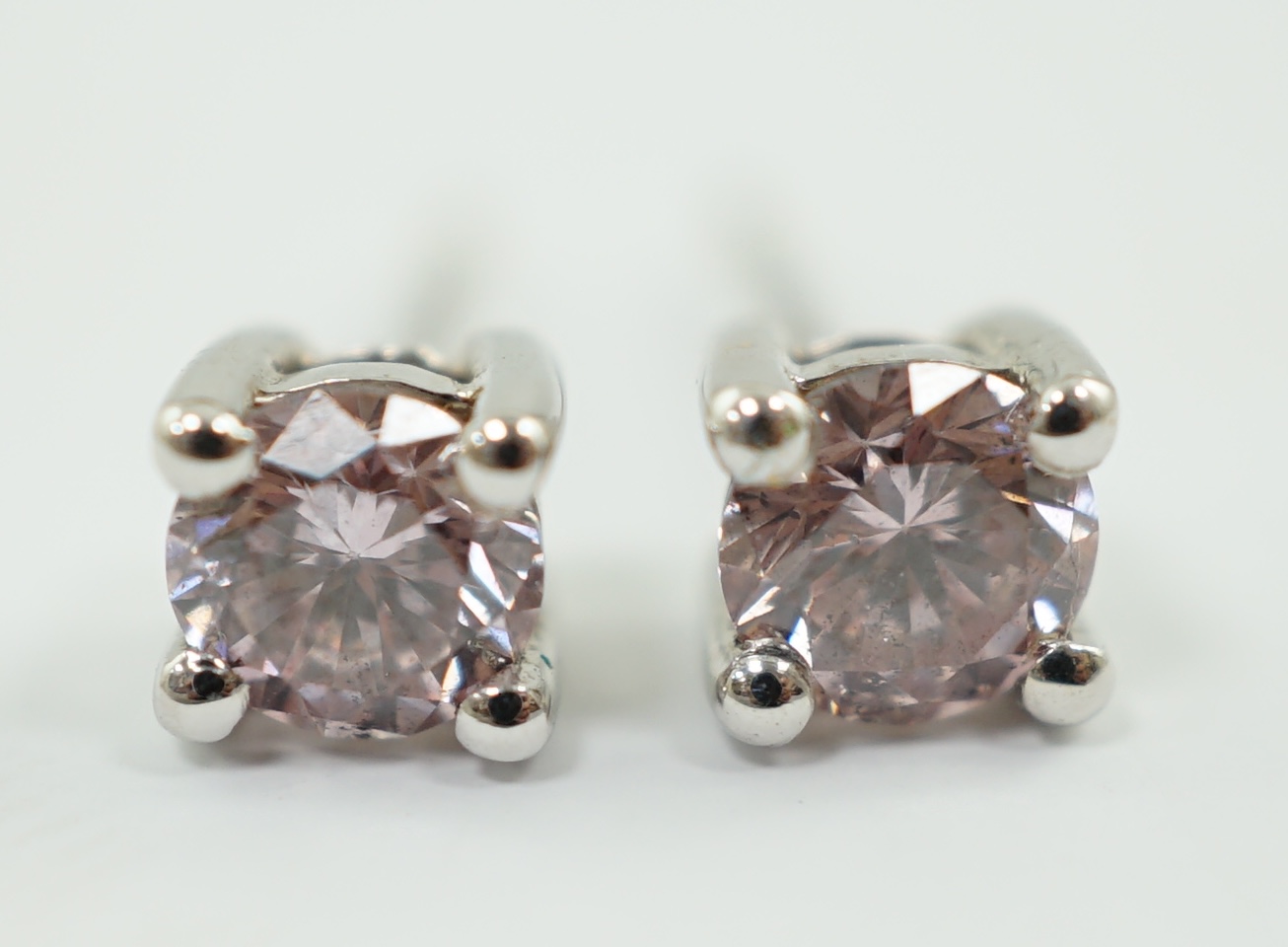 A modern pair of 18k white gold and round brilliant cut solitaire diamond eat studs